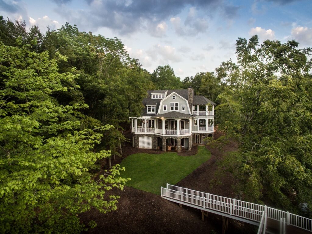 A house with stairs going up to it's front yard.