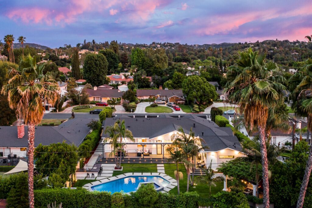 A view of houses and swimming pools from above.